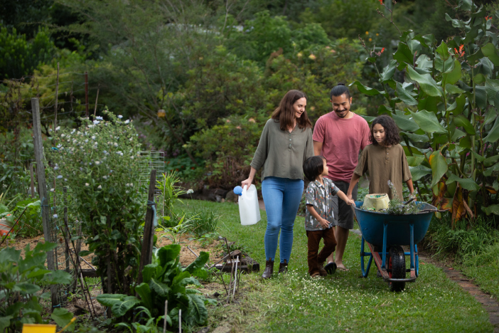 A family walking through a community garden