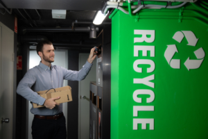 a man putting items in a recycling bin
